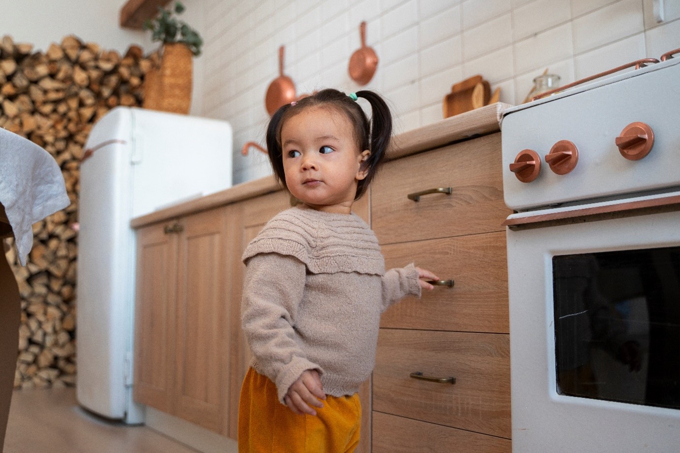 Little girl exploring the kitchen